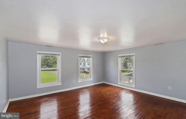 spare room with wood-type flooring