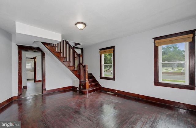 empty room with dark hardwood / wood-style flooring