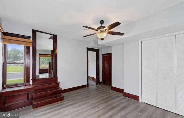 unfurnished bedroom featuring ceiling fan and hardwood / wood-style flooring