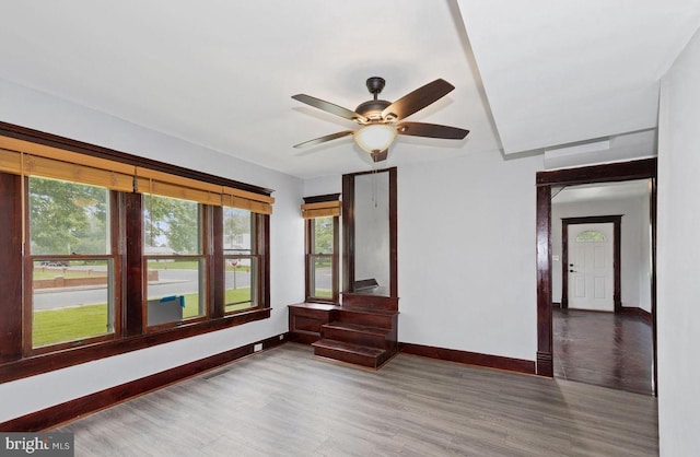 unfurnished room featuring hardwood / wood-style floors, ceiling fan, and plenty of natural light