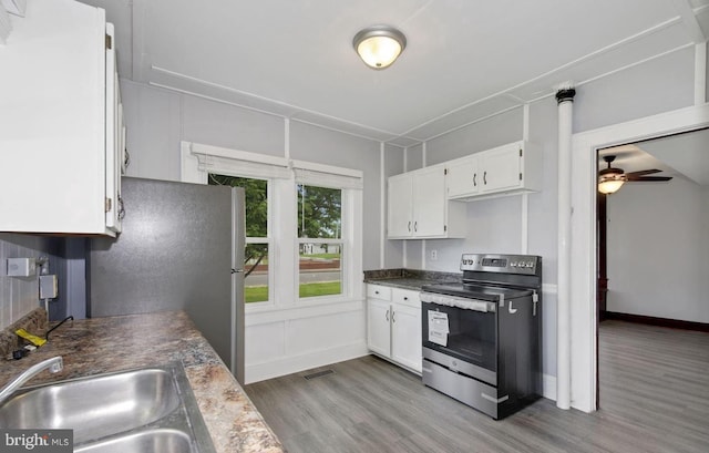 kitchen with ceiling fan, sink, light hardwood / wood-style flooring, white cabinetry, and stainless steel appliances