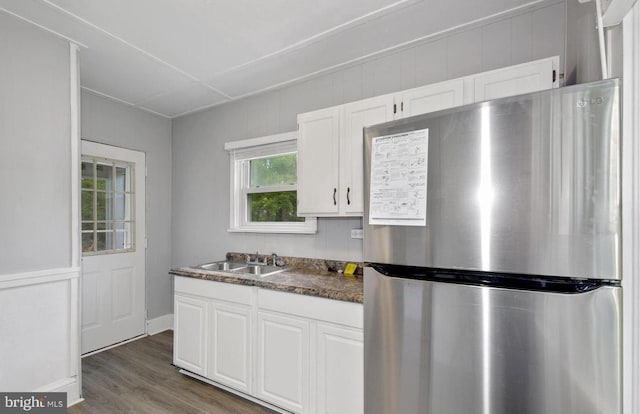 kitchen with white cabinets, sink, stainless steel fridge, and dark hardwood / wood-style floors