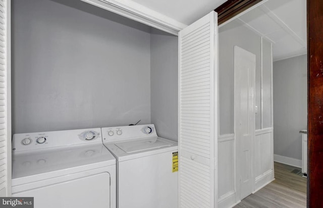 washroom featuring separate washer and dryer and light hardwood / wood-style floors