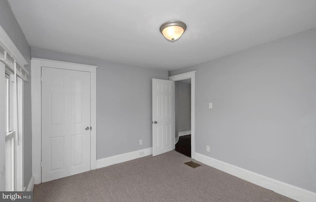 unfurnished bedroom with carpet floors