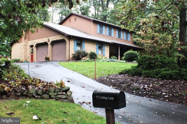 view of front facade with a garage and a front lawn