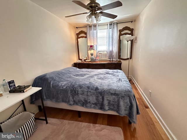 bedroom with hardwood / wood-style floors and ceiling fan