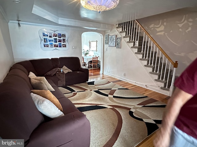 living room featuring hardwood / wood-style floors and crown molding