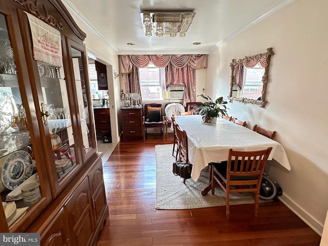 dining space featuring ornamental molding and dark wood-type flooring