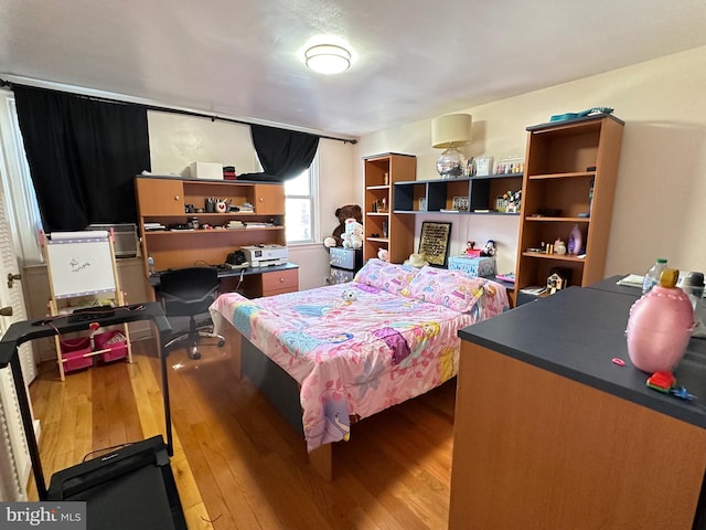 bedroom with hardwood / wood-style floors