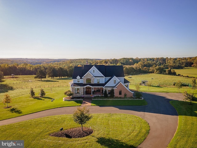 view of front of property featuring a front yard and a rural view