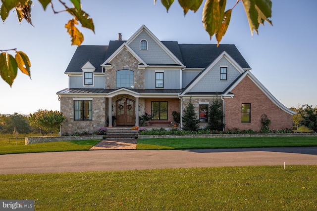 view of front facade with covered porch and a front lawn