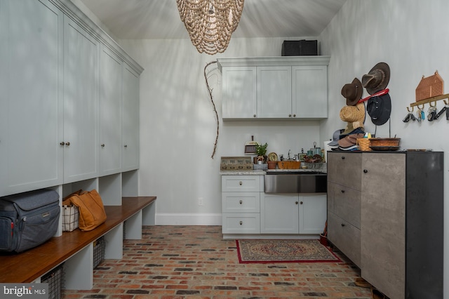 interior space with sink and white cabinets