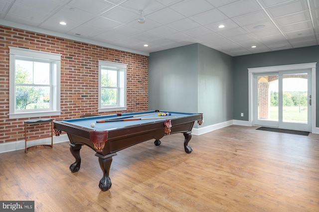 rec room featuring brick wall, pool table, and light wood-type flooring