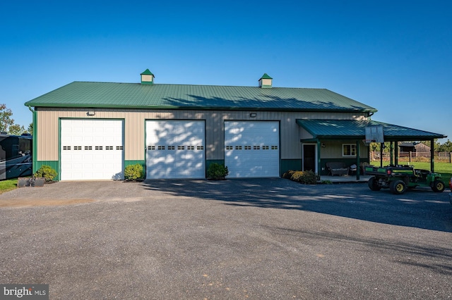 view of front of home with a garage and metal roof