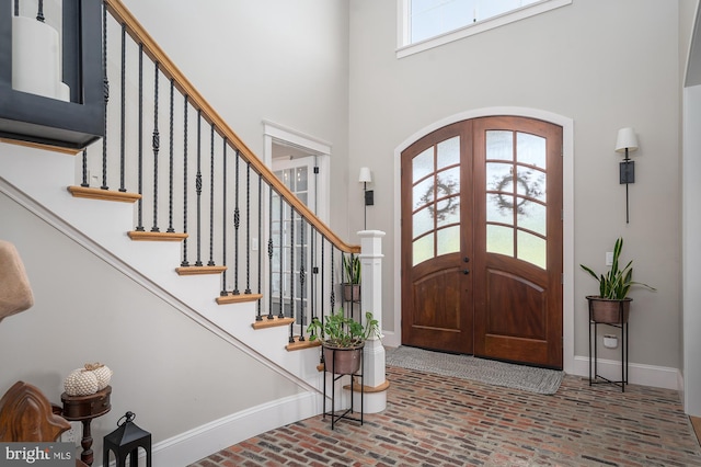 entryway featuring a towering ceiling