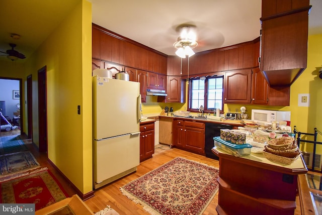 kitchen with white appliances, ceiling fan, light hardwood / wood-style floors, and sink