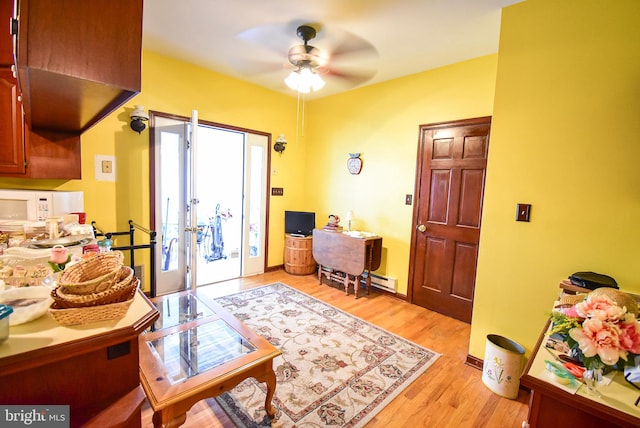 interior space featuring light hardwood / wood-style floors and ceiling fan