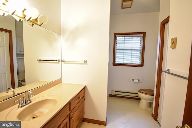 bathroom with a baseboard radiator, vanity, and toilet