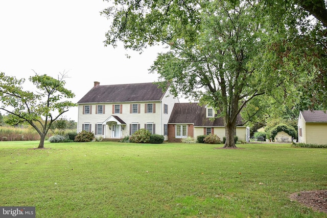 colonial-style house with a front yard