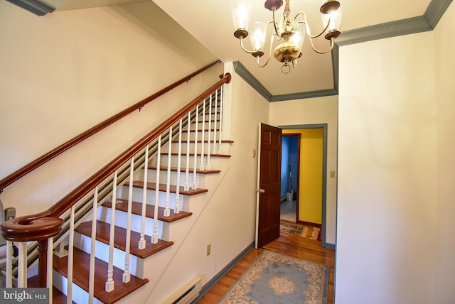 stairs with crown molding, a chandelier, and hardwood / wood-style flooring