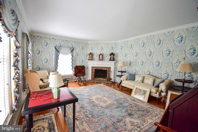 living room with wood-type flooring, crown molding, and a brick fireplace