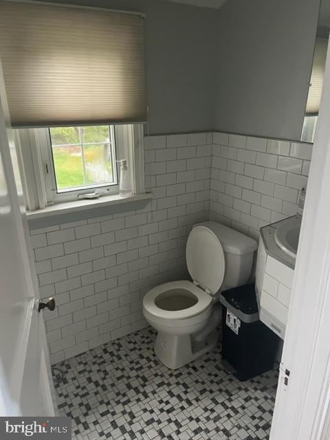 bathroom with vanity, tile walls, toilet, and tile patterned floors