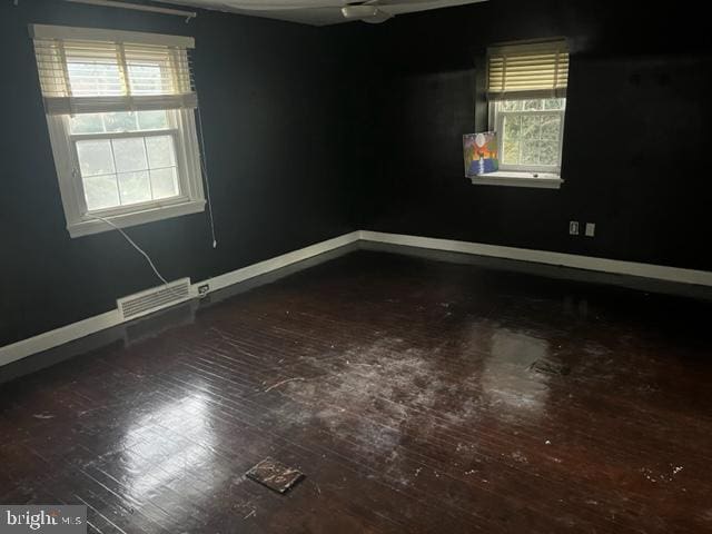 spare room with ceiling fan and hardwood / wood-style flooring