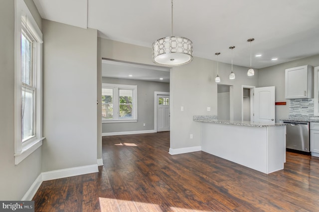 kitchen featuring light stone counters, dark hardwood / wood-style floors, white cabinets, kitchen peninsula, and dishwasher