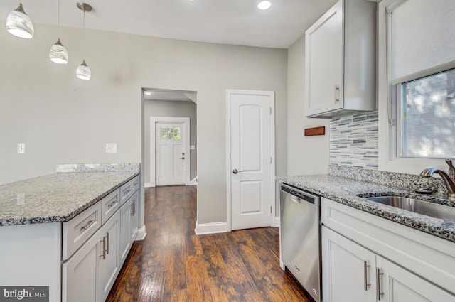 kitchen with dark wood-type flooring, decorative light fixtures, light stone counters, white cabinets, and stainless steel dishwasher