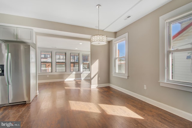 unfurnished dining area with dark hardwood / wood-style flooring