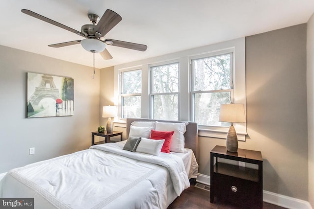 bedroom with ceiling fan and dark wood-type flooring