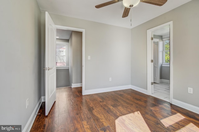 interior space with ceiling fan and dark hardwood / wood-style flooring