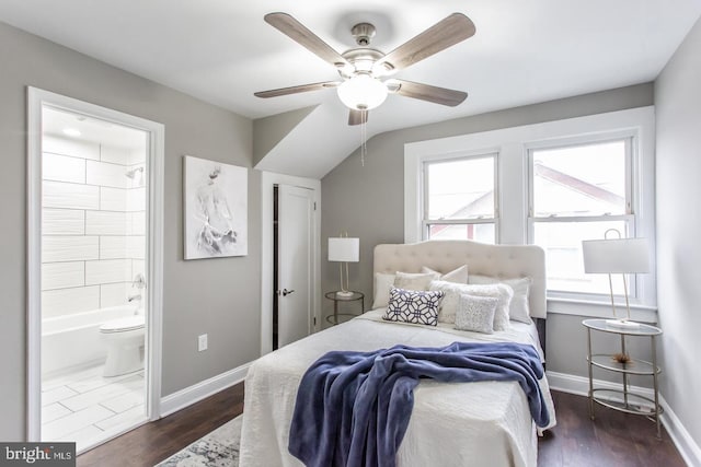 bedroom with ceiling fan, dark wood-type flooring, and connected bathroom