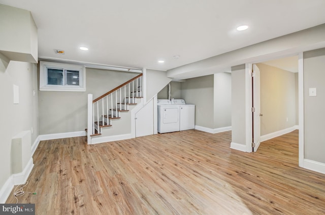 basement with separate washer and dryer and light hardwood / wood-style floors