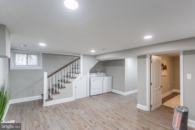 basement featuring light hardwood / wood-style flooring and washer and dryer