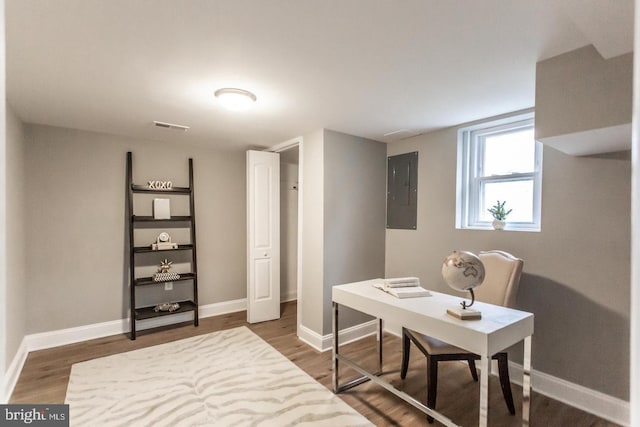 office area featuring electric panel and dark hardwood / wood-style flooring