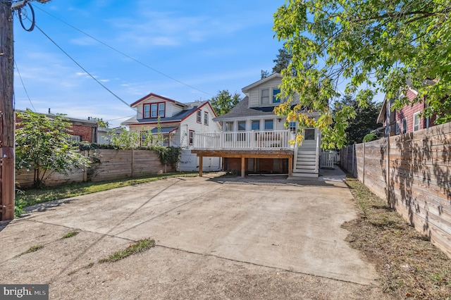 back of house with a wooden deck