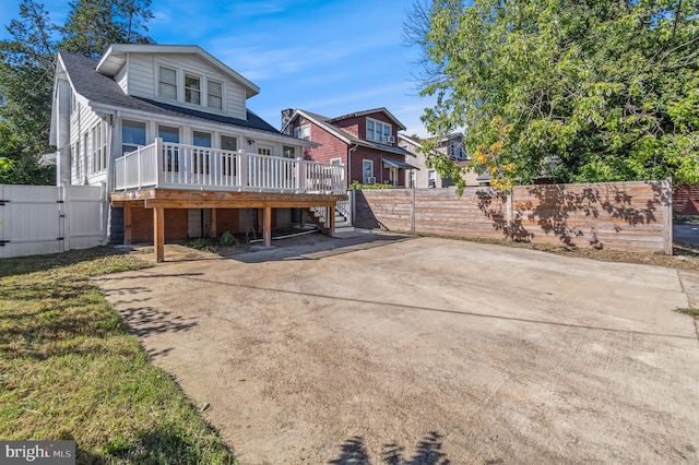 back of property featuring a deck and a carport