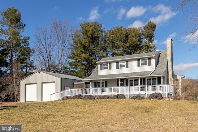 view of front of property with a garage, a porch, an outbuilding, and a front yard