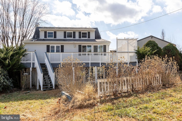 rear view of property with a wooden deck