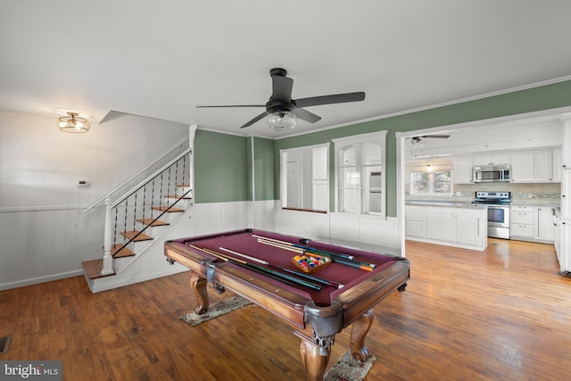 recreation room with wood-type flooring, ceiling fan, crown molding, and billiards