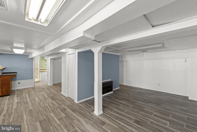 basement featuring dark hardwood / wood-style floors