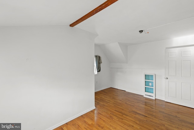 bonus room with lofted ceiling with beams and hardwood / wood-style flooring