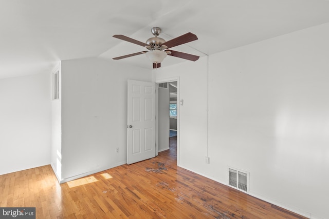 unfurnished room featuring ceiling fan, vaulted ceiling, and light hardwood / wood-style flooring