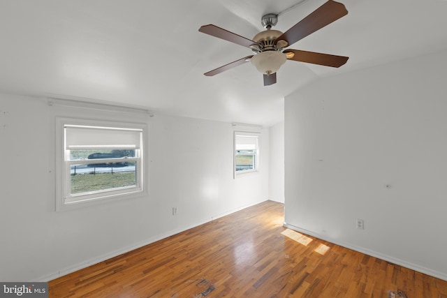 unfurnished room featuring vaulted ceiling and hardwood / wood-style floors