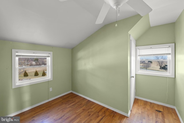 bonus room with lofted ceiling, a healthy amount of sunlight, and hardwood / wood-style floors