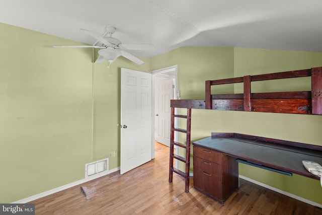 bedroom featuring ceiling fan, vaulted ceiling, and light wood-type flooring