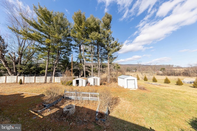 view of yard with a rural view and a storage unit