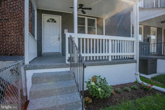 property entrance featuring ceiling fan and a porch