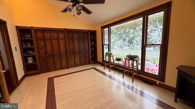 interior space with lofted ceiling and ceiling fan